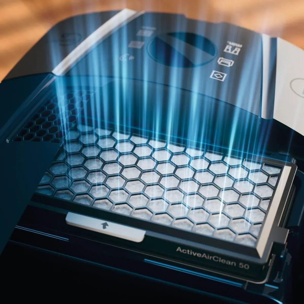 Close-up of a genuine Miele ActiveAirClean 50 filter cartridge seated in a vacuum, with airflow drawn through the honeycomb filter